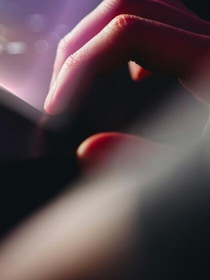 Hand on a laptop trackpad