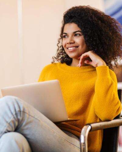 Social engineering-woman yellow jumper laptop-content-800x1000