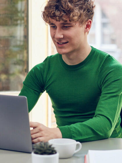 About dynamic interventions-man green jumper laptop-content-840x1120