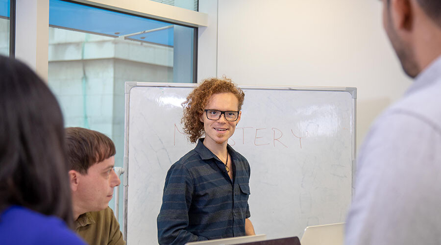 Careers-employees collaborating whiteboard-content-900x500